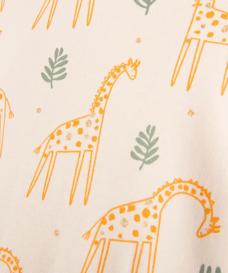 Grenouillère écru à motifs girafes et touches pailletées